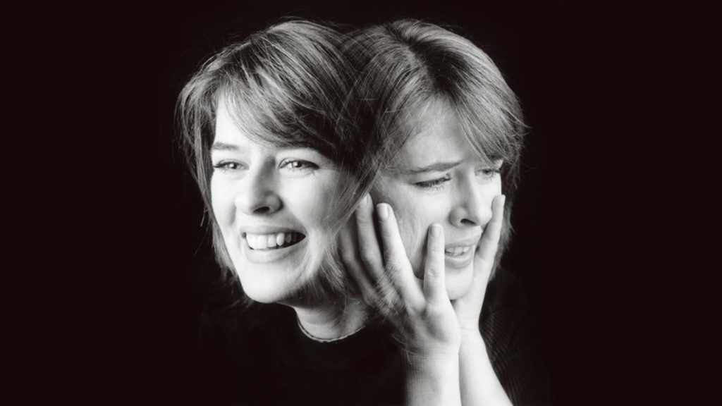 Black-and-white image of a woman showing two faces—one smiling, one distressed—representing the mood swings of Bipolar II Disorder.
